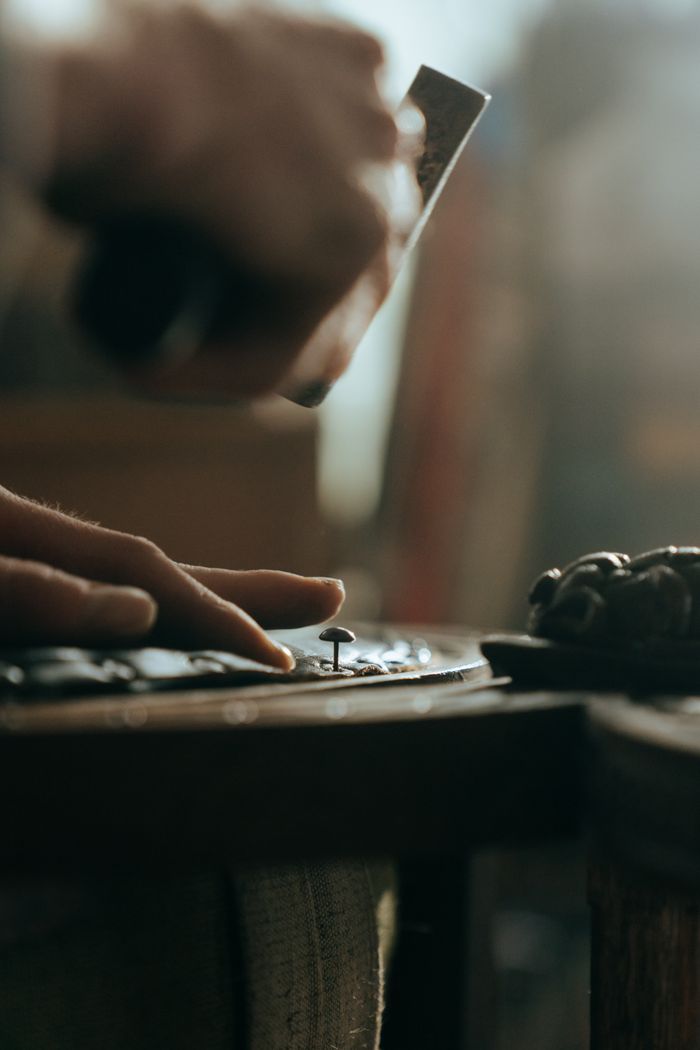 gallery-1 Close-up of a craftsman restoring wooden furniture with precision and skill.